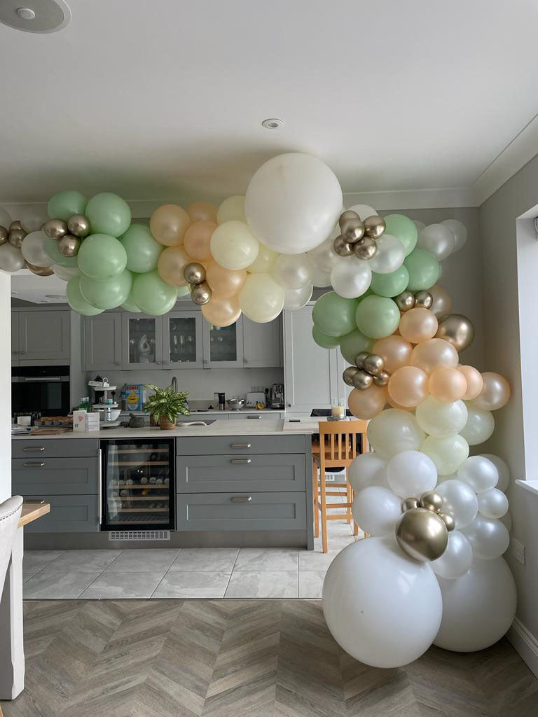 Organic balloon Arch in shades of Sage Green Blush Chrome Gold and Pearl White