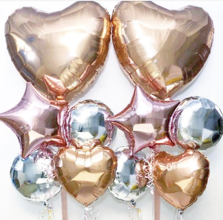 Glamorous bunch of foil balloons . A large heart shaped balloon at the top with 4 star round and heart shaped balloons underneath all weighted in a bunch .Perfect srprise bunch of balloons for a birthday a party ,valentine day.